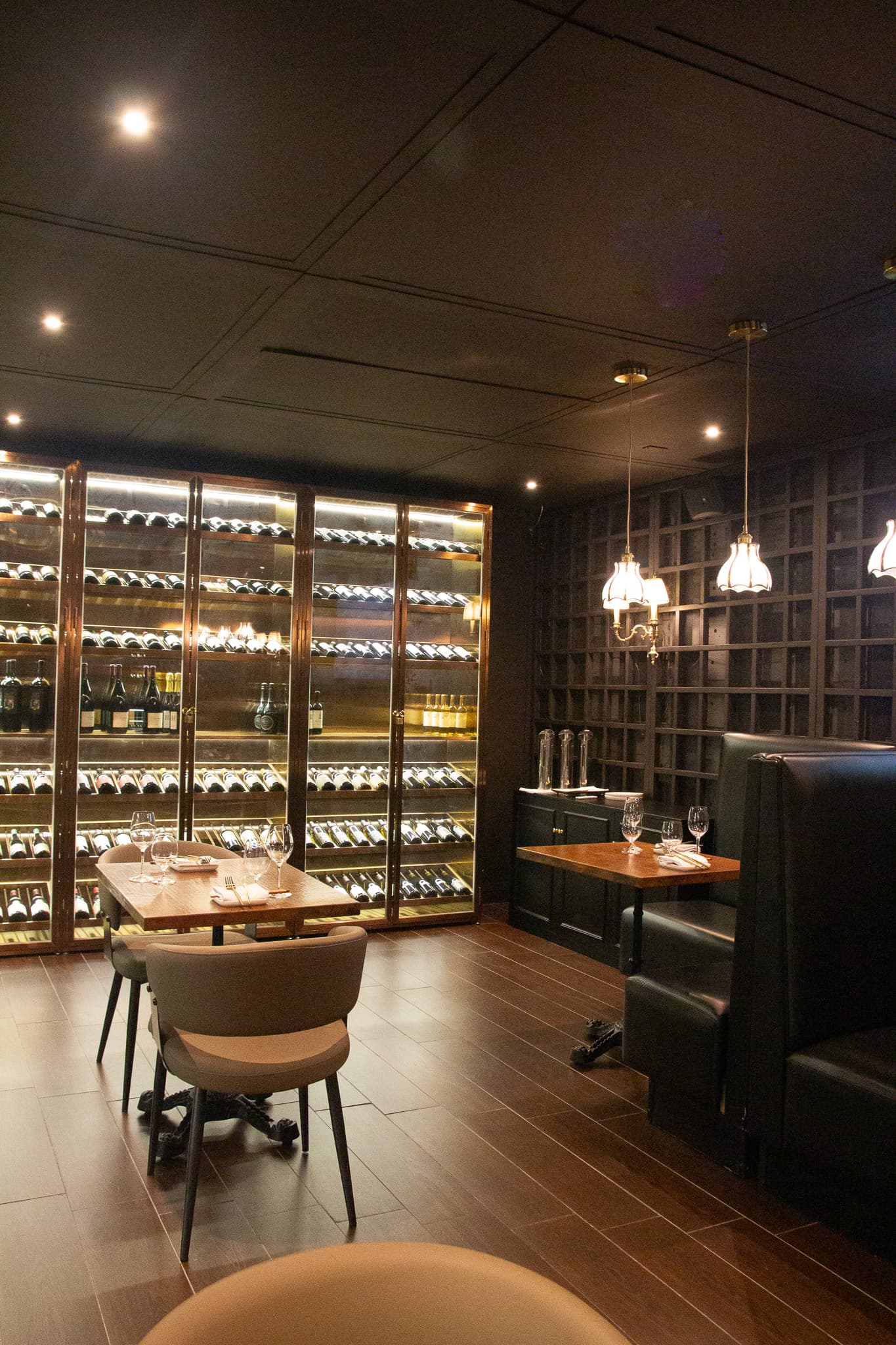 An intimate table set against The Vault wine wall