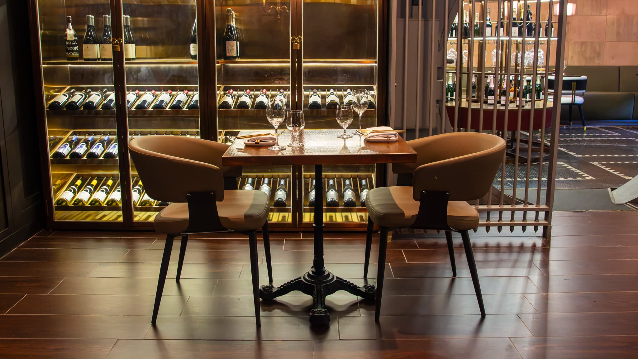 Private table for two beside The Vault wine wall